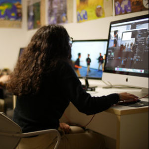 Femal student on computer using editing software